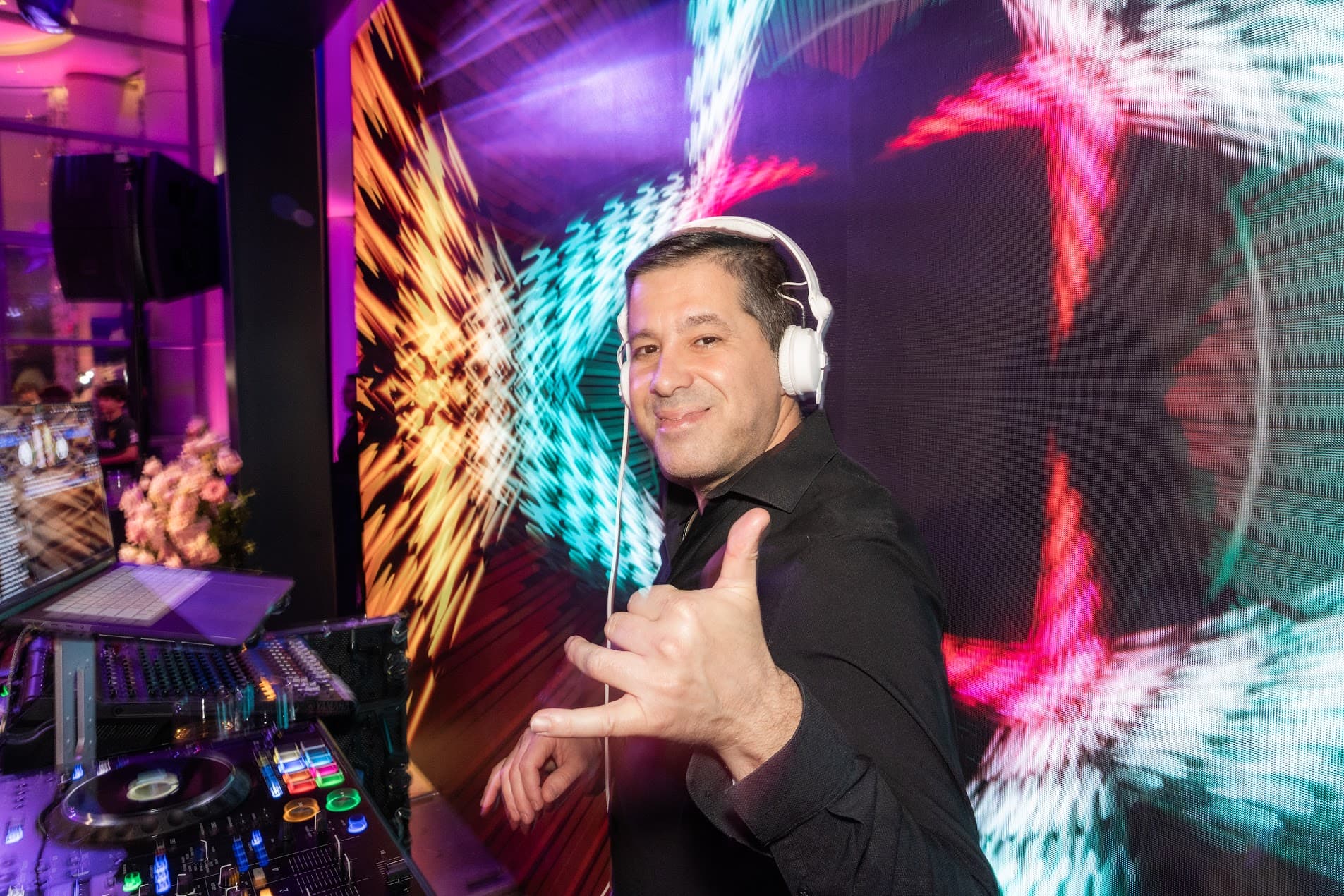 DJ Gilad Emesh mixing in front of an LED wall at a Los Angeles celebration